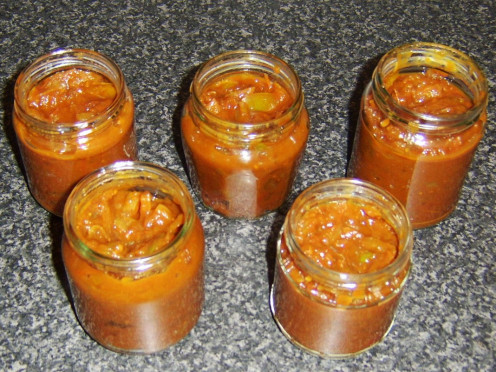 Tomato pickle carefully ladled in to jars