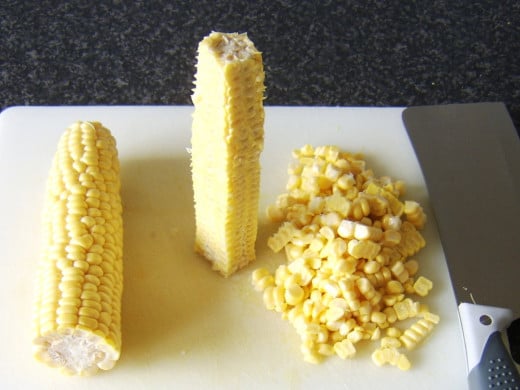 Removing the kernels from the corn ears