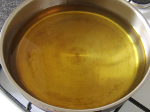 About an inch of oil is added to a deep frying pan