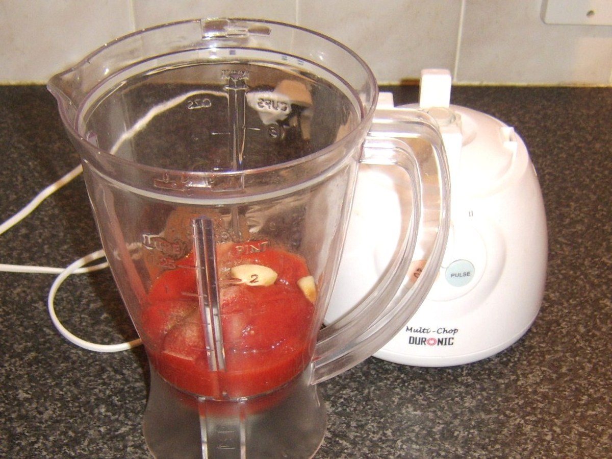 Preparing to blitz tomato sauce ingredients