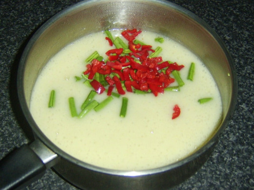 Chilli and green beans are added to soup