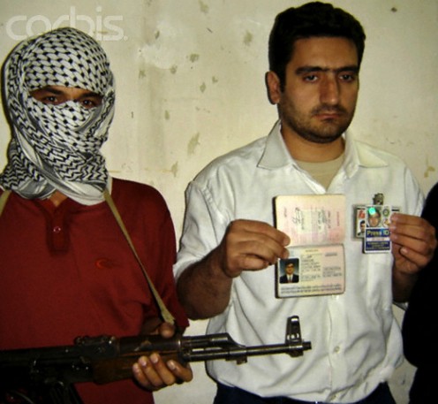 Terrorist holds hostage with firearm.