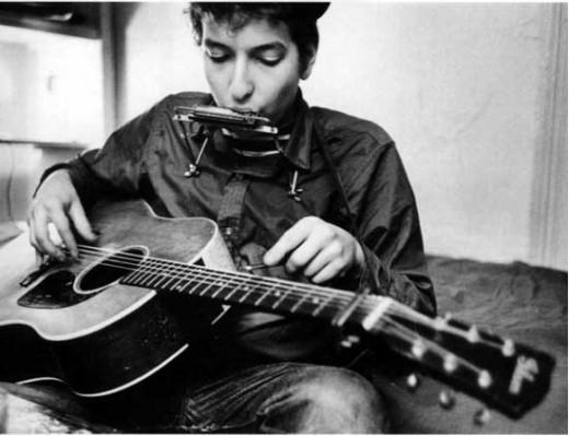 Bob Dylan with guitar and harmonica