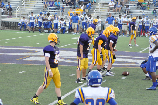 Here my son playing a game on the turf field in his yellow Nike cleats. He is at wide receiver in an early season freshman football game.