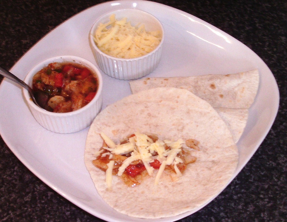 Grated cheese scattered over fajitas spiced jellied cod