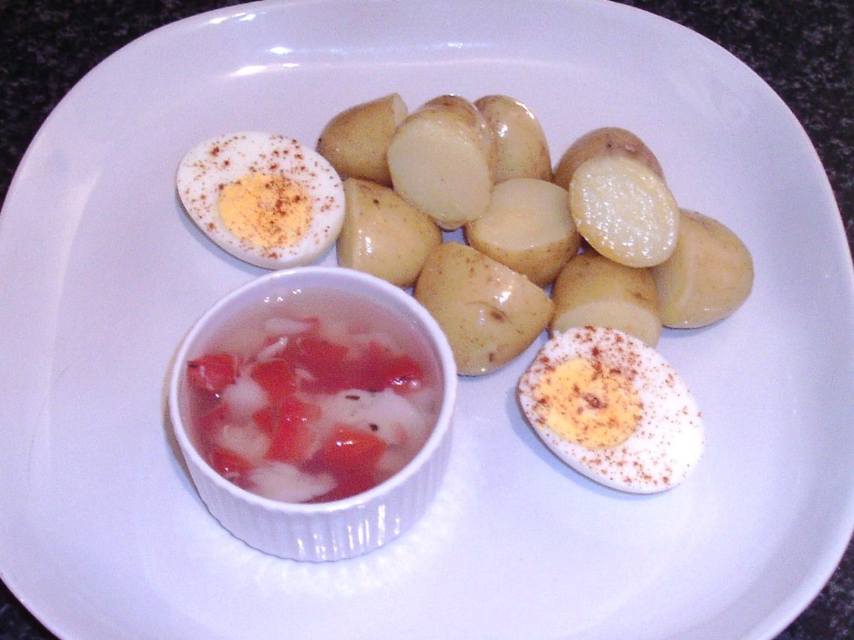 Egg and potatoes are plated with jellied cod