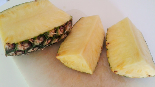 Quartered pineapples show their woody center, making it easy to chop it off.