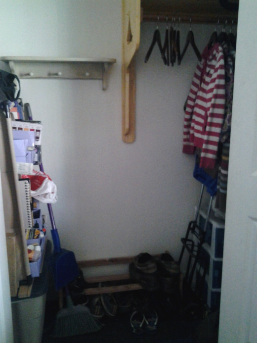 Finished hall closet (see 1st project)  with organizer, coat rack that features a carved boat on one side, shoe rack, and peg board for bags and accessories.