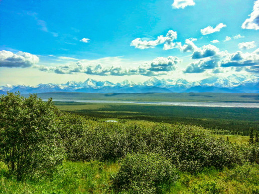The 400-mile procession of peaks known as the Alaska Range rises steeply above the central Alaskan tundra.