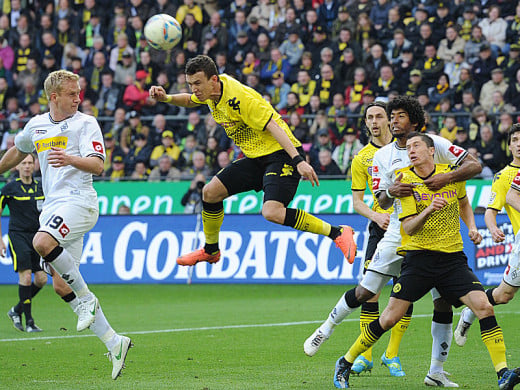 Ivan Perisic heads in the opening goal of Borussia Dortmund's match against Borussia Mönchengladbach in a Bundesliga match. Dortmund clinched a second consecutive Bundesliga title with the 2-0 victory. 