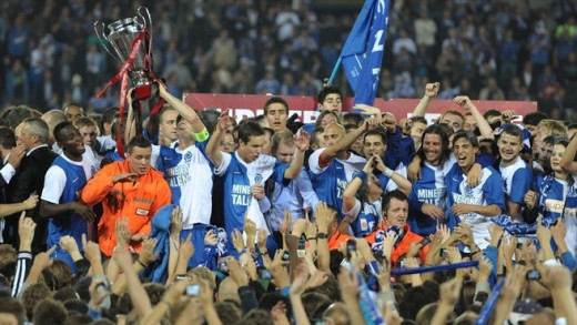Players celebrate with fans after Genk won Belgium's Jupiler League. Genk did so despite finishing second in the overall standings due to a unique playoff format.