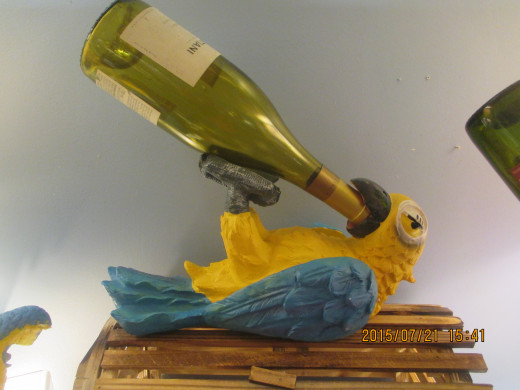 Despite the cute Cape Cod souvenir, alcohol is not good for your parrot.