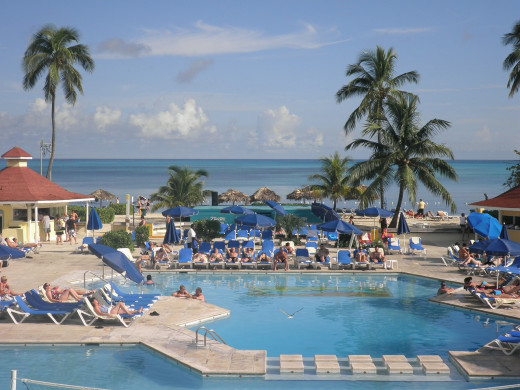 Vacationers relaxing by a pool in the Bahamas.