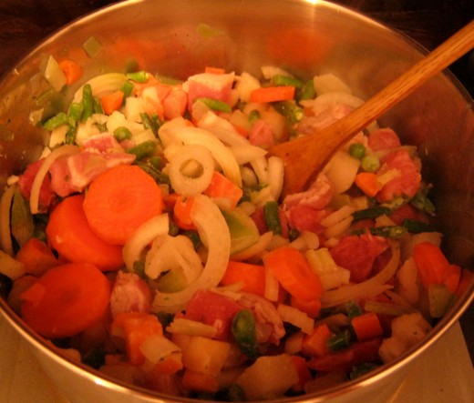 Tossing meat and vegetables in fat.