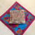 Lay pillow with corners pointing towards the sides of a square scarf. Lay pillow with corners pointing towards the sides of a square scarf.