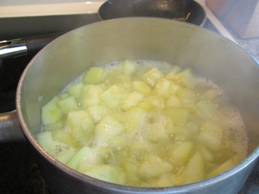 Zucchini chopped and cooking in pan.