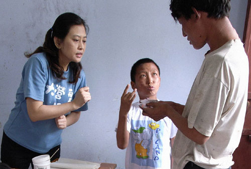A volunteer talks with a patient in a leprosy-plagued village in Taiwan