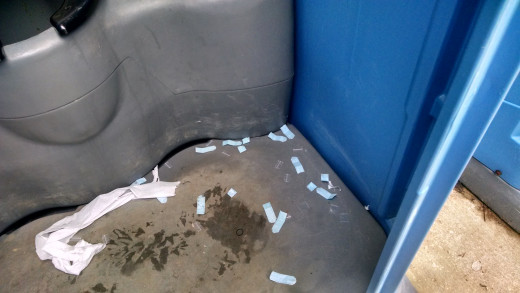 The remains of heroin packaging on the floor of a Port-A-Potty at a gas station just north of Milford De. 01/25/2015 2 PM.  An example of the glamorous life of an addict. 