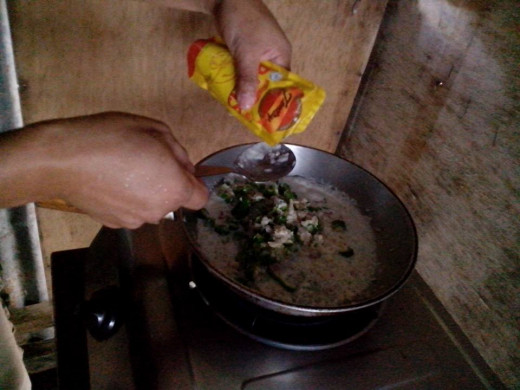 Sauteing pili nuts , rice, spices and enhancing the flavor with patis, or fish sauce. Photo Source: Ireno Alcala