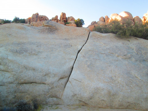 A crack in the large rock.
