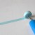 Coiling two strips of blue quilling paper. Coiling two strips of blue quilling paper.