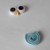 Stick the eyes and beak together. Shape the blue coil to look like a tulip flower. Stick the eyes and beak together. Shape the blue coil to look like a tulip flower.