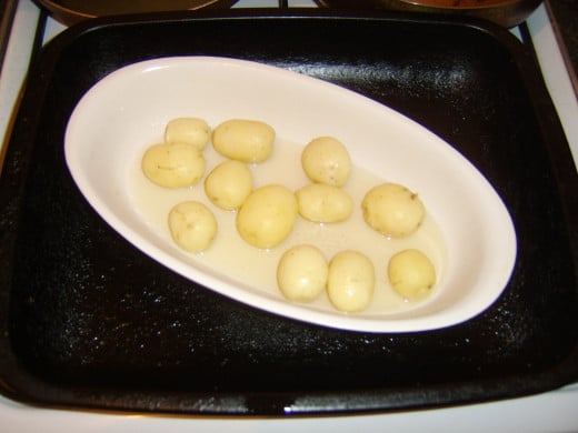 Potatoes are added to hot goose fat for roasting