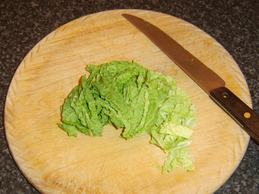 Savoy cabbage leaves are roughly shredded