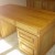 One image of a normal looking oak writing desk. One image of a normal looking oak writing desk.