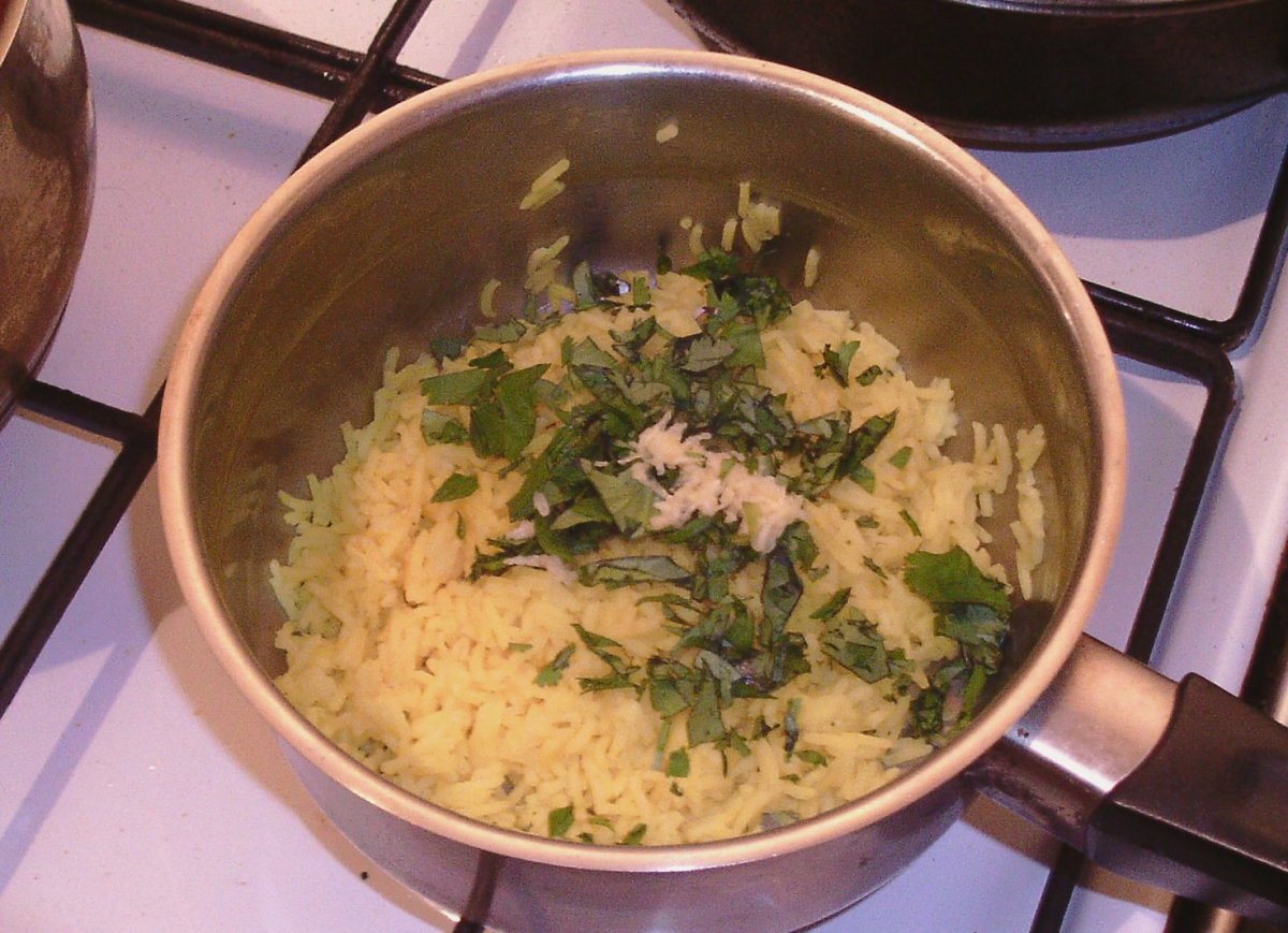 Garlic and coriander/cilantro added to turmeric rice
