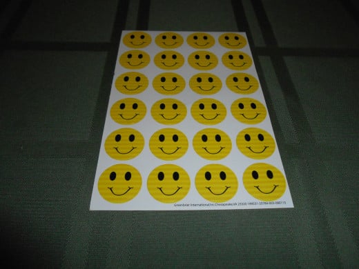 The smiley face stickers. One will be included with each note card.