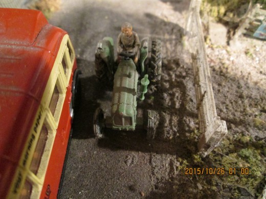 Not far away, on the bridge across the railway, a tractor driver makes his way home - most likely with traffic building up behind! (figure manipulated to fit onto tractor seat)