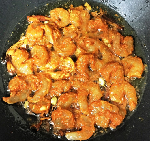 Stir fry the marinated shrimp in whole garam masala and oil.