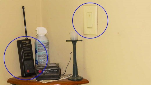 Wire through garage wall powers receiver for train remote control device (lower circle). Switch (upper circle) turns outdoor lighting on & off.