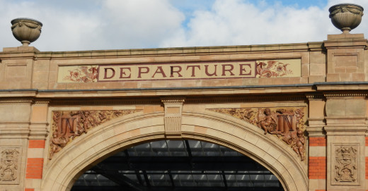 The Wyvern emblem of the Midland Railway sit on both sides of  the "DEPARTURE" entrance.