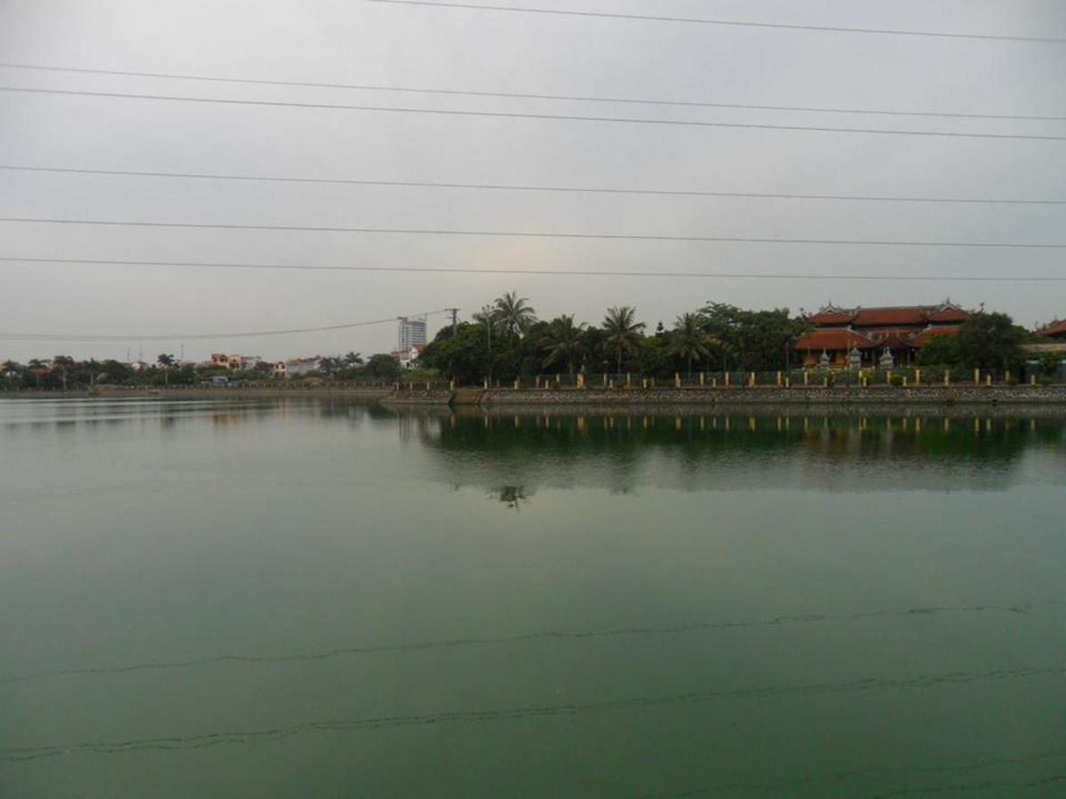 A point of view crossing An Bien - Dao Lake (Hồ Đào) toward the An Da Buddhist Temple (Chùa An Đà)
