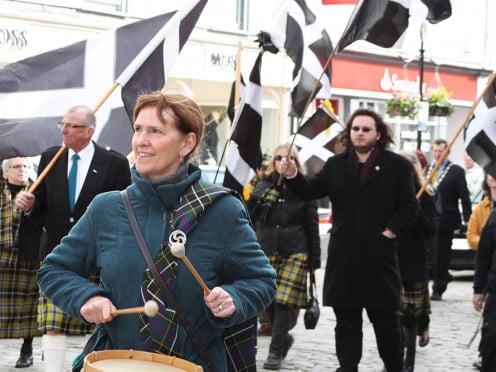 Parade in Cornwall with Cornish flag - black with white cross.