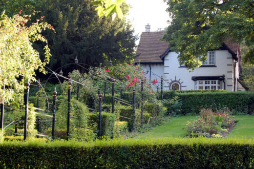 Beautiful gardens use a variety of plant types to contrast and compliment each other. As you can see in this image, use of flowers, herbs and shrubs add dimension and visual interest to this English garden. 