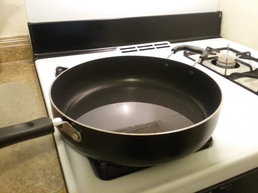Get a large frying pan and add about a 1/4 to a half inch of cooking oil. Heat on medium high.