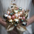 Some flowers would not be able to hold up well in the winter time. The Christmas ornaments as a bouquet is clever idea.