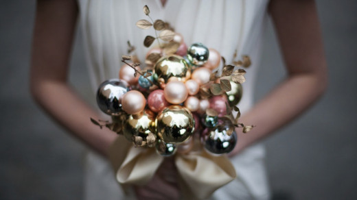 Some flowers would not be able to hold up well in the winter time. The Christmas ornaments as a bouquet is clever idea.