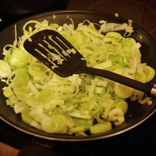 The leeks and onion frying in the pan in step one.