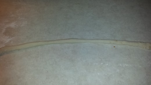 Roll a ball of dough into an 18" to 24" long Snake or rope on the counter