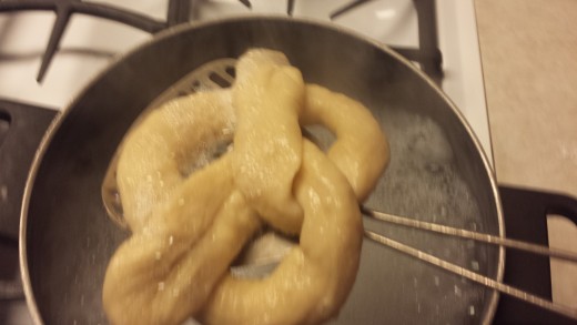 Scoop the pretzels from the water with a large flat spatula. The pretzels will have grown in size.