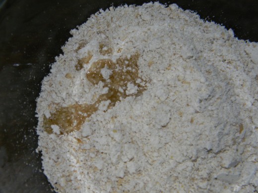 Add the sweet almond oil - or coconut oil or olive oil - to the oatmeal and mix it.