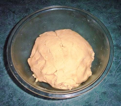 Ingredients combine to make peanut butter cookie dough.