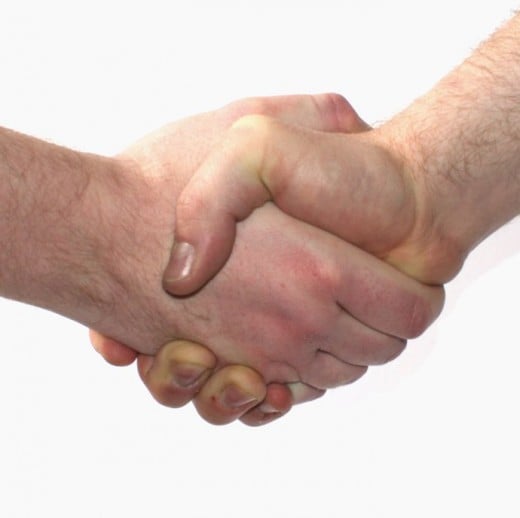 Always offer a handshake at the beginning and end of a job interview.  It's standard business practice, except during a pandemic.