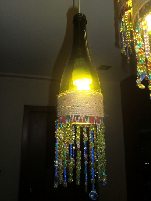 After wrapping the beaded cloth to the wine bottle, I wrapped the jute twine around the fabric part, of course with the help of a strong glue. This added to the boho-look of my chandelier apart from giving it a solid, finished look.