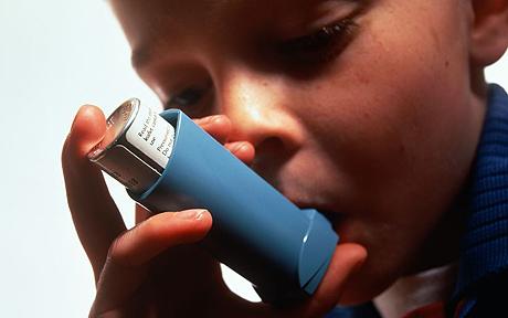 A child using an inhaler.
