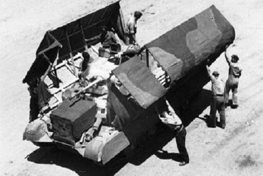 The process of disguising a tank to make it look like a truck. Rommel was convinced when he saw pictures, then the wraps came off...